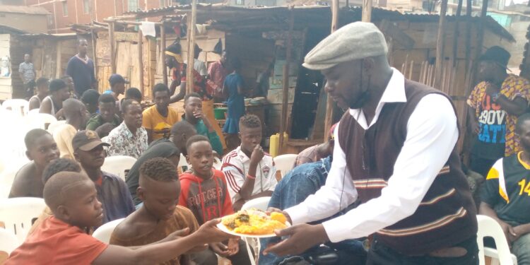 Pastor Kakeeto sharing food with the kids