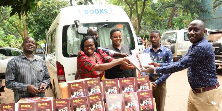 Prof Consolota Kabonesa (second left) receiving the books titled 'Gender and Socio-Economic Change’