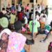 Refugees in Adjumani attend a health talk at Pagirinya Health Centre III courtesy of RHU