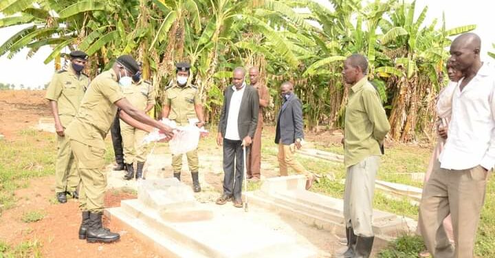 Police officers, PC Amos Kungu's relatives at the grave of the fallen officer