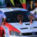 Rajiv (left) standing next to his rally car