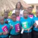 Sharlotte Niwagaba (center) after handing over scholastic materials to vulnerable children in Kijura Town Council