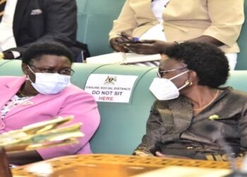 Dr Moriku (L) interacting with health minister, Dr Jane Ruth Acheng, during plenary on Wednesday, 09 February 2022