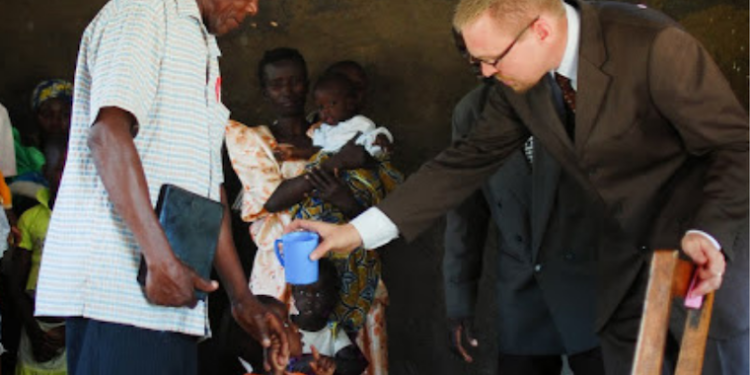 Eric-Tuininga-baptising-a-child-in-Mbale