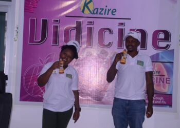 Employees of Kazire Health Products showing some of their health drinks during the  Ugandan Investment Symposium