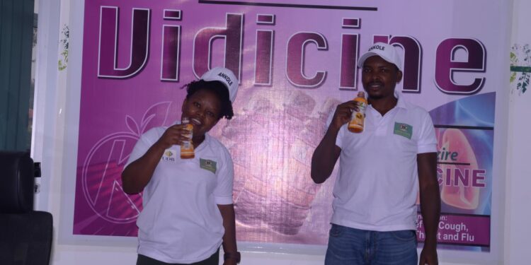 Employees of Kazire Health Products showing some of their health drinks during the  Ugandan Investment Symposium