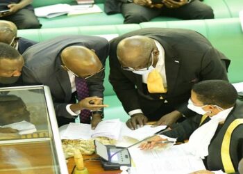 Committee chairperson, Emmanuel Otaala (L), Deputy Attorney General, Jackson Kafuuzi (C)and State minister for Minerals, Peter Lokeris consulting Deputy Speaker Anitah Among