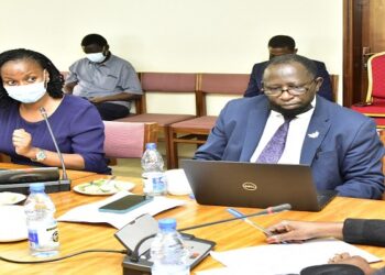 Dr Balinda (with mask) before the committee chaired by Hon Ababiku (R)