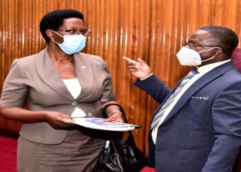 Dr Byanyima (L) speaking to Hon. Rutahigwa, the Rukungiri Municipality MP after appearing before PAC(Central Gov't)