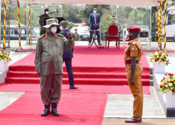 President Museveni talks to Gassi Christine one of the best female students during the pass out at Kololo on Friday. PPU Photo 01