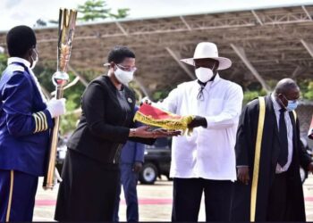 President Yoweri Museveni handing over instruments of power to Rt Hon Anita Among