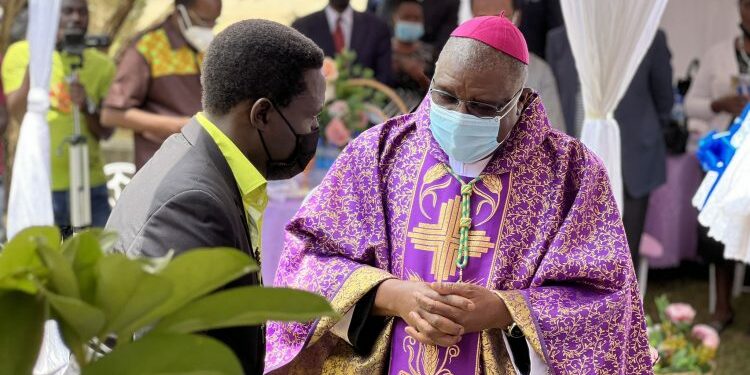 Archbishop Ssemogerere with herbalist David Ssenfuka