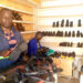 Simon Musisi Wesonga nga agatta engatto mu kkampuni ye eya WESOM SHOES LTD