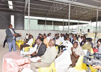 The Head of the industrial hubs and Presidential projects in Uganda Eng. Kamugisha Raymond (left) giving a lecture during a meeting that was being attended by Political leaders from BukedI Sub-region in Lwatama Village in Kibuku District at the Presidential Initiative For Industrial Zonal Hub Bukedi Sub-region on 13th April 2022. Photo by PPU / Tony Rujuta.