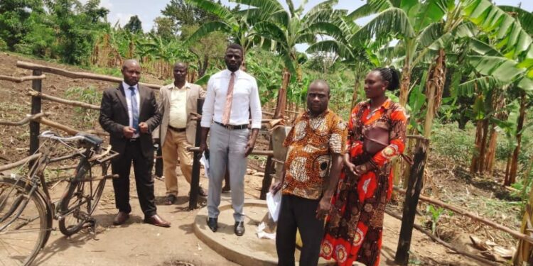 Deputy RDC Tumusiime (white shirt) with the district LC5 chairman, Yosia Ndibwami