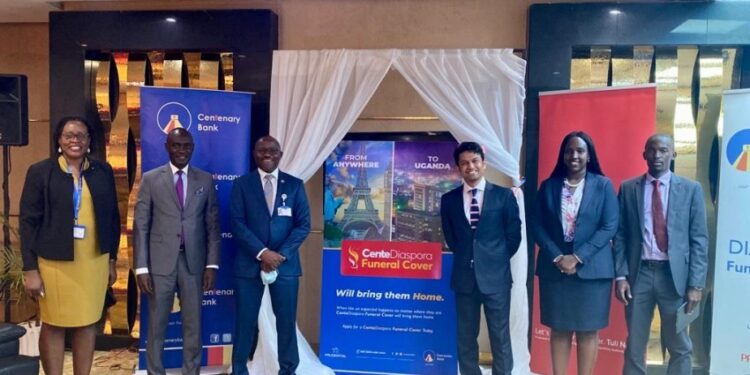 Fabian Kasi the Managing Director at Centenary Bank (3rd left) and Mr. Arjun Mallik then CEO Prudential Eastern and Central Africa (3rd right) alongside other officials from the Bank and Prudential Uganda pose for a photo during the launch of the Diaspora Funeral Cover at Mapeera House. The bank rolled out several innovations in 2021 on which it is hedging its future growth.