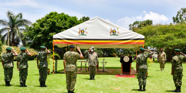 CDF Gen Mbadi (C) and a team of five officers salute the Commander in Chief Gen Museveni during the high command meeting at Entebbe