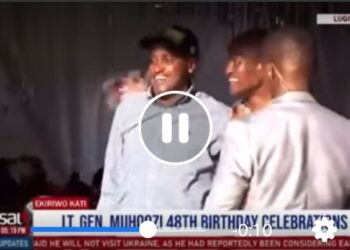 Tamale Mirundi and Minister Frank Tumwebaze hug during  Gen Muhoozi's birthday party