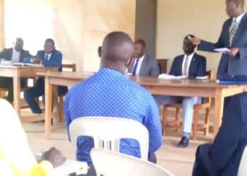 Kagadi Deputy Resident District Commissioner Tumusiime, DISO in a meeting with district councilors and other officials