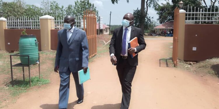 Alebtong RDC Adiama and his Deputy Odongo (black suit)