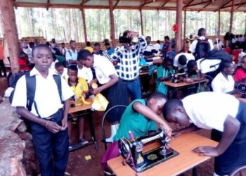 Students learning how to use tailoring machines