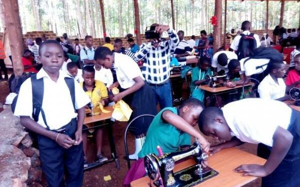 Students learning how to use tailoring machines