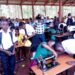 Students learning how to use tailoring machines