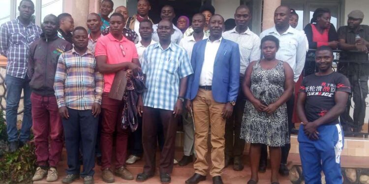 Fort Portal DRCC Allan Bamuha in a group photo with Members of Boda Boda riders SACCO