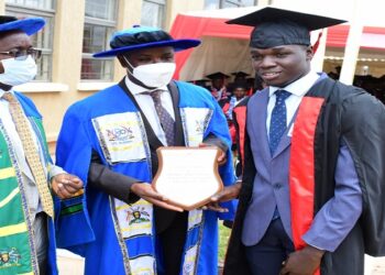 Deputy Speaker Thomas Tayebwa (centre) flanked by Eng Silver Mugisha presents an award to a best performing student at UTCB