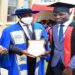 Deputy Speaker Thomas Tayebwa (centre) flanked by Eng Silver Mugisha presents an award to a best performing student at UTCB