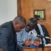 Dr Kizza Besigye with one of his lawyers Erias Lukwago in Court