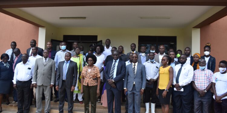 The Minister Pose with the staff of Gulu University