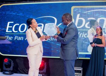 Ms Grace Muliisa, the Ecobank Managing Director (left) hands over a plaque to Mr. Kin Kariisa, the outgoing Ecobank board Chairman (right) in appreciation of his “hands-on” and always-on service to the bank. She said that Kariisa’s leadership and passion for technological advancement had influenced the bank’s huge investments in Digital Transformation, which have now started paying off for the bank and its customers.