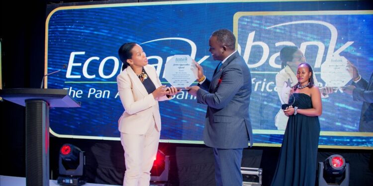 Ms Grace Muliisa, the Ecobank Managing Director (left) hands over a plaque to Mr. Kin Kariisa, the outgoing Ecobank board Chairman (right) in appreciation of his “hands-on” and always-on service to the bank. She said that Kariisa’s leadership and passion for technological advancement had influenced the bank’s huge investments in Digital Transformation, which have now started paying off for the bank and its customers.