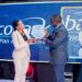 Ms Grace Muliisa, the Ecobank Managing Director (left) hands over a plaque to Mr. Kin Kariisa, the outgoing Ecobank board Chairman (right) in appreciation of his “hands-on” and always-on service to the bank. She said that Kariisa’s leadership and passion for technological advancement had influenced the bank’s huge investments in Digital Transformation, which have now started paying off for the bank and its customers.