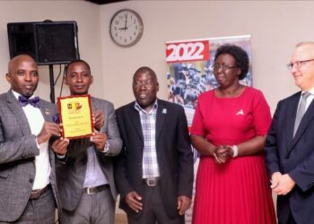 Dr Lawrence Muganga (left) receiving his Award