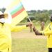 President Yoweri Museveni handing the party flag to Andrew Ojok