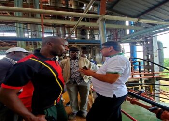 MPs on a tour of the factory in Nwoya.