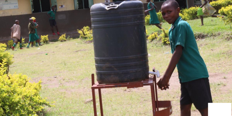 A pupil at Ibanda primary school washing hands