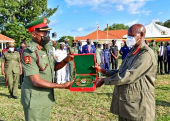 Brig. Gen Godwin Obina from Nigeria presents a gift to President Museveni shortly after the President's  opportunity lecture to officers from Nigeria National Defense College held at Baralege in Otuke on Friday