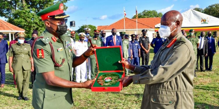Brig. Gen Godwin Obina from Nigeria presents a gift to President Museveni shortly after the President's  opportunity lecture to officers from Nigeria National Defense College held at Baralege in Otuke on Friday