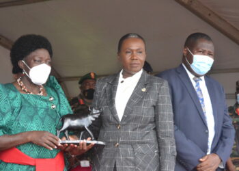 First Deputy Prime Minister and Minister of East African Community Ms Rebecca Kadaga(Left)receives a gift from Ms Angelina Teny ,Minister of National Defence and War Veterans Republic of South Sudan(Centre) and State Minister for Defence Jacob Oboth Oboth during the function at Gaddafi Barracks on Friday.