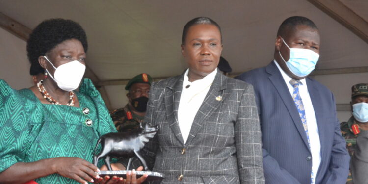 First Deputy Prime Minister and Minister of East African Community Ms Rebecca Kadaga(Left)receives a gift from Ms Angelina Teny ,Minister of National Defence and War Veterans Republic of South Sudan(Centre) and State Minister for Defence Jacob Oboth Oboth during the function at Gaddafi Barracks on Friday.