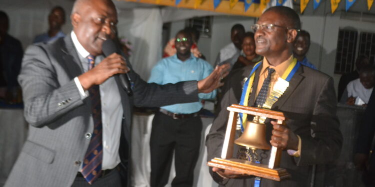 Rotarian Emmanuel  Katongole(Left)  proprietor  of Quality Chemicals Industries installing The Former Chief brewer at Nile Breweries Ltd Mr Moses Musisi(Right) as President of Rotary Club of Jinja.