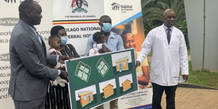 Habitat Director Robert Otim and Dr John Sekabira with parents of twins at Mulago June 15, 2022