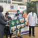 Habitat Director Robert Otim and Dr John Sekabira with parents of twins at Mulago June 15, 2022