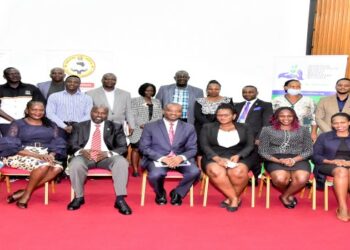 Participants in a group photo at the meeting. Hon. Silas Aogon (seated, centre) is the forum chairperson