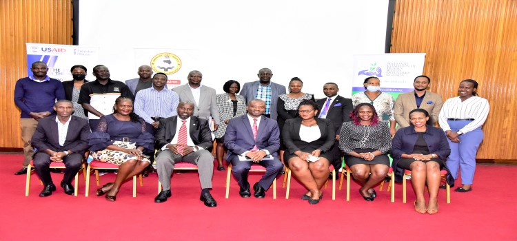 Participants in a group photo at the meeting. Hon. Silas Aogon (seated, centre) is the forum chairperson
