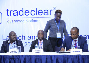 I&M Bank Uganda’s Head of Treasury Denis Damba (R) signs onto Tradeclear on behalf of the bank.