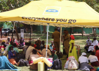 Stranded pilgrims gathered in a tent